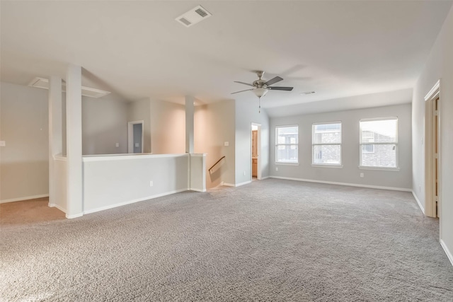 carpeted spare room with baseboards, visible vents, and a ceiling fan