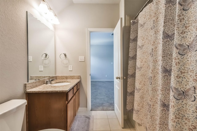 full bathroom with a shower with shower curtain, vanity, toilet, and tile patterned floors