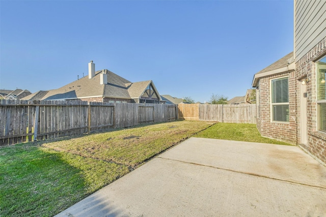 view of yard with a patio area and a fenced backyard