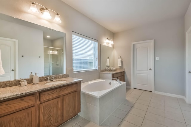 bathroom featuring a stall shower, two vanities, a sink, tile patterned flooring, and a bath