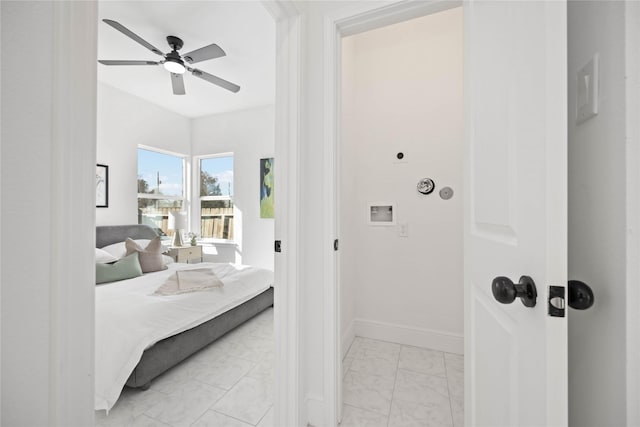 bedroom featuring marble finish floor, ceiling fan, and baseboards