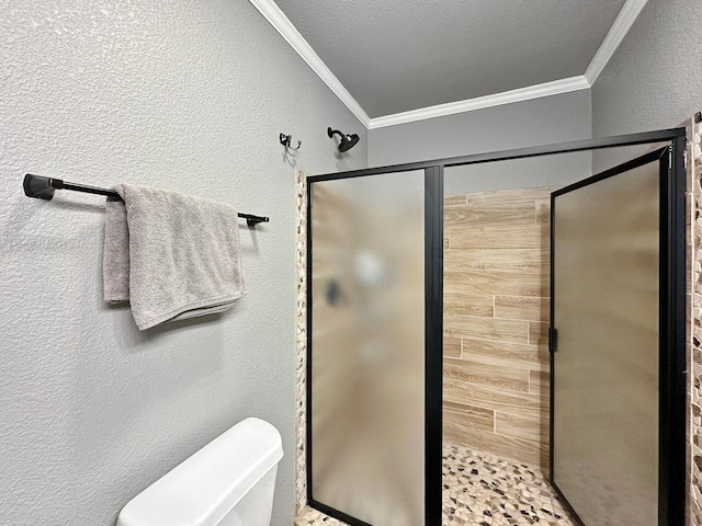 bathroom featuring toilet, a stall shower, crown molding, and a textured wall