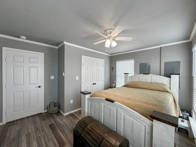 bedroom featuring dark wood-style floors, ornamental molding, a textured ceiling, and baseboards