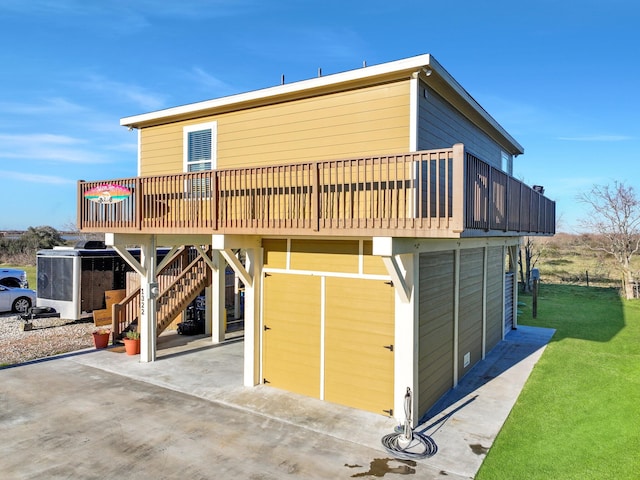 back of property featuring a deck, a yard, stairway, and a patio