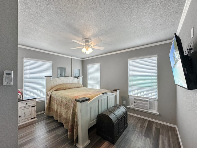 bedroom with dark wood-style floors, a textured wall, ornamental molding, and multiple windows