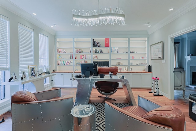 home office with baseboards, crown molding, light wood-type flooring, built in shelves, and recessed lighting