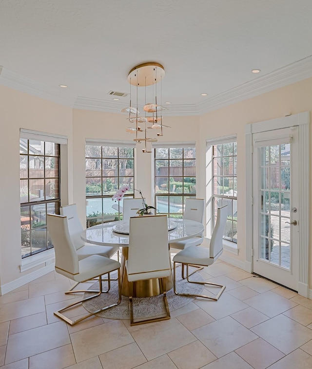 dining space with a wealth of natural light, ornamental molding, and visible vents