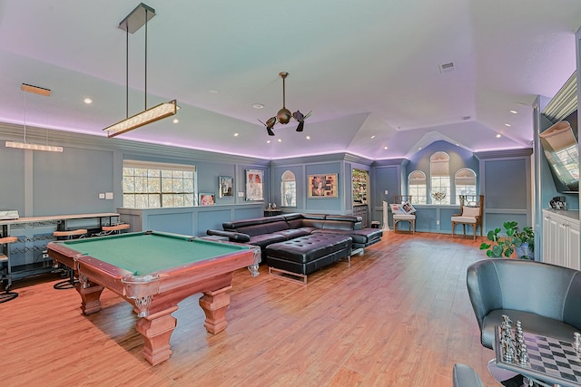 rec room featuring lofted ceiling, a decorative wall, billiards, visible vents, and light wood finished floors