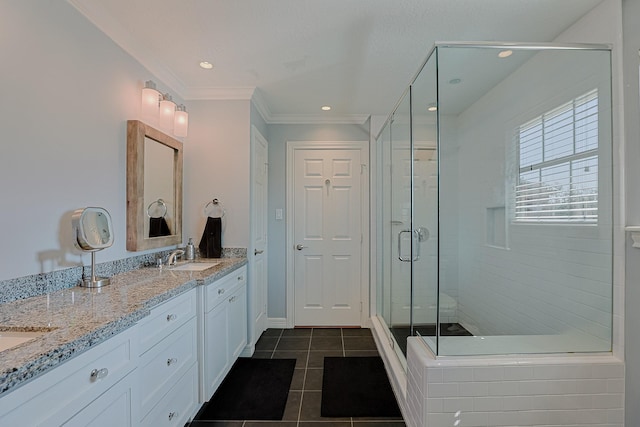 full bathroom with tile patterned flooring, a sink, ornamental molding, double vanity, and a stall shower