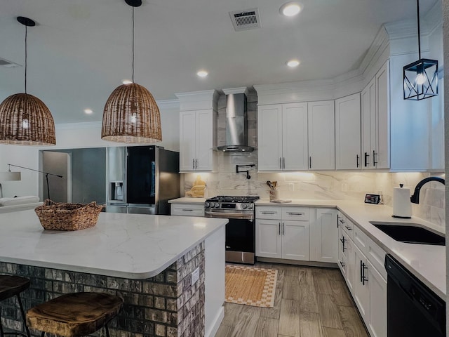 6804 Broadleaf Dr, Beaumont, TX 77708 - kitchen featuring black appliances, wall chimney exhaust hood, a sink, white cabinets, and wood finished floors