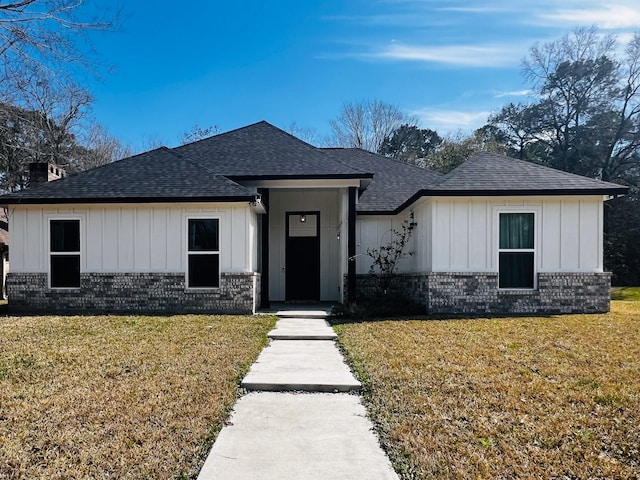 6804 Broadleaf Dr, Beaumont, TX 77708 - view of front facade with a shingled roof, brick siding, and a front lawn
