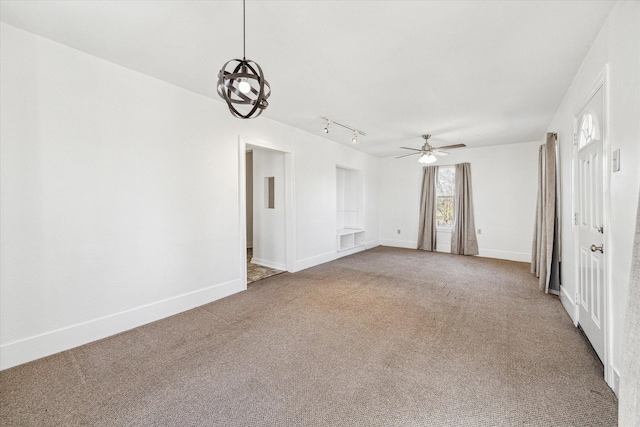 spare room featuring baseboards, carpet, and a ceiling fan