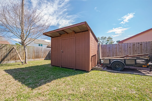 view of shed with a fenced backyard