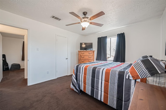 bedroom with ceiling fan, a textured ceiling, visible vents, and carpet flooring