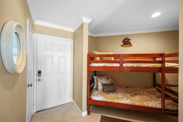 entryway with baseboards, crown molding, and tile patterned floors