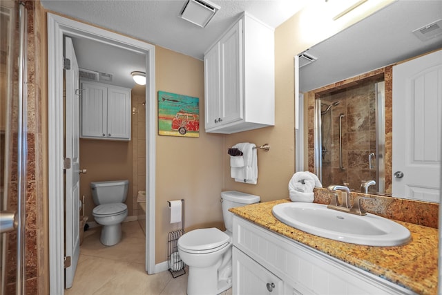 full bath with toilet, a stall shower, visible vents, and vanity