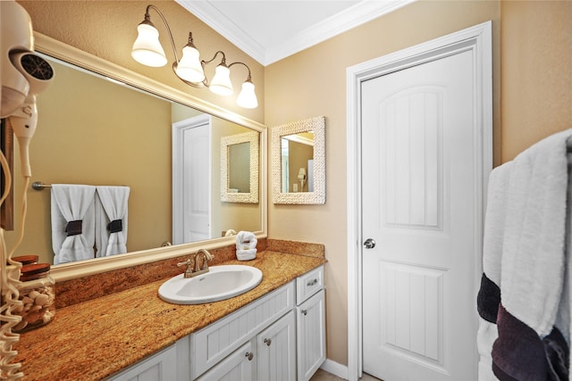 bathroom with crown molding and vanity