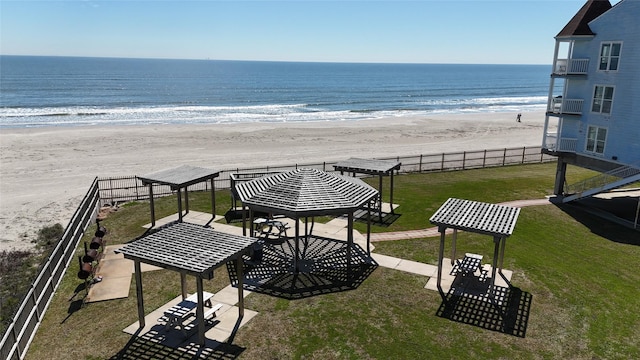 balcony featuring a water view and a beach view