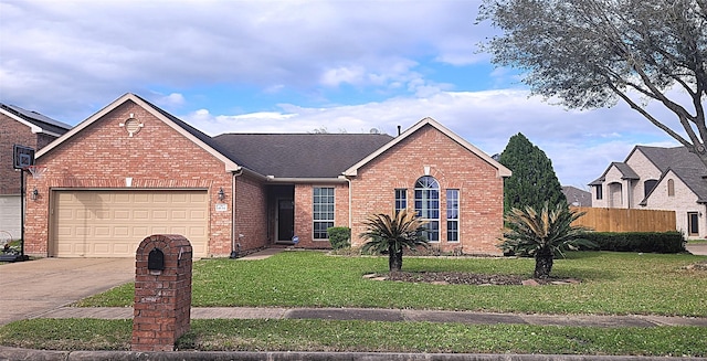 view of front of property with driveway, brick siding, an attached garage, and a front yard