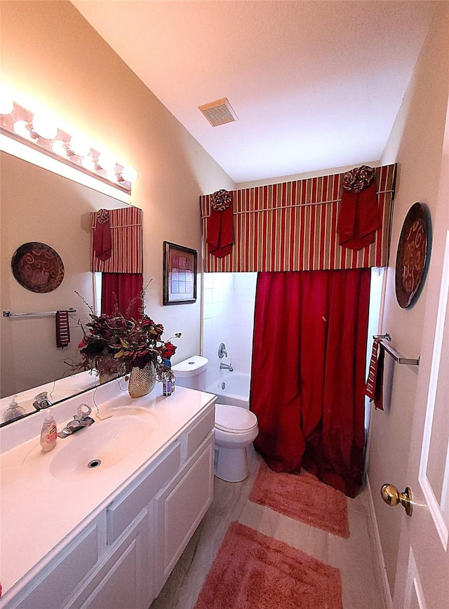 bathroom featuring visible vents, vanity, toilet, and shower / bath combo with shower curtain