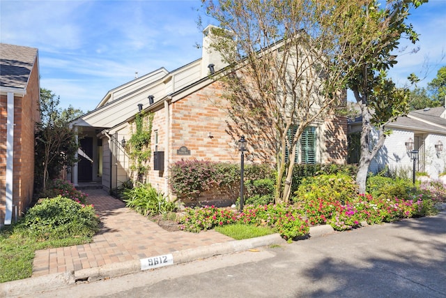 view of side of property featuring brick siding