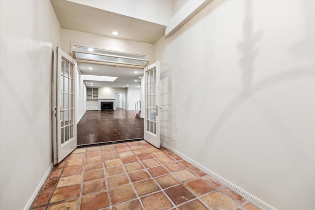 hallway with french doors, recessed lighting, tile patterned flooring, and baseboards