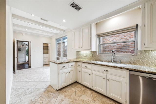 kitchen featuring beam ceiling, visible vents, a sink, dishwasher, and a peninsula