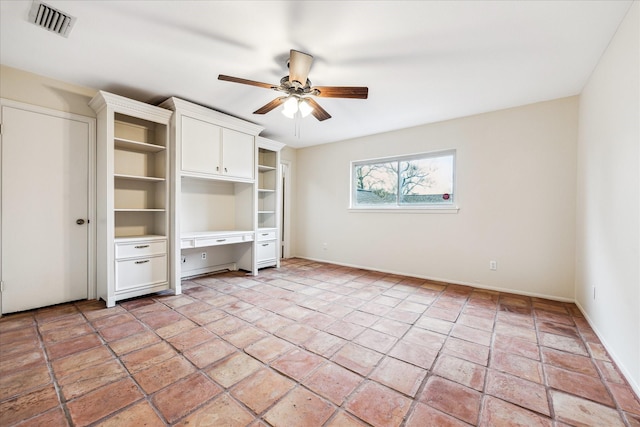 unfurnished bedroom with ceiling fan, visible vents, and built in study area