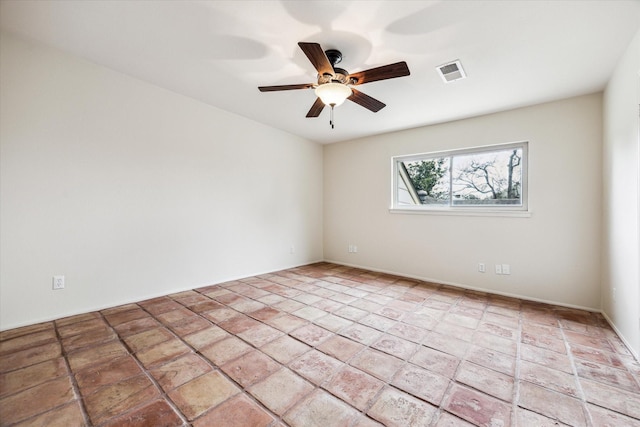 spare room featuring ceiling fan and visible vents