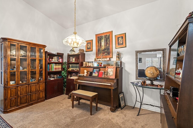 living area featuring carpet and a notable chandelier