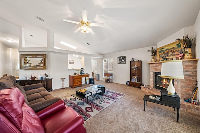 living room featuring visible vents, a ceiling fan, vaulted ceiling, carpet flooring, and a brick fireplace