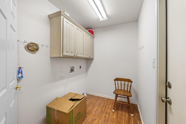 washroom with hookup for a washing machine, wood finished floors, baseboards, cabinet space, and electric dryer hookup