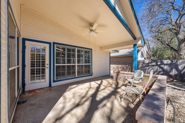 view of patio / terrace with ceiling fan and fence