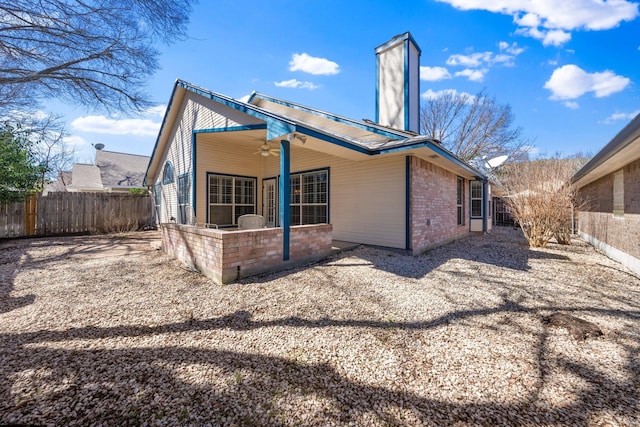 back of house featuring a fenced backyard, ceiling fan, brick siding, and a patio