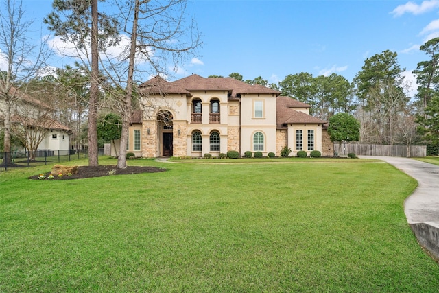 view of front of property featuring a front yard, fence, and stucco siding