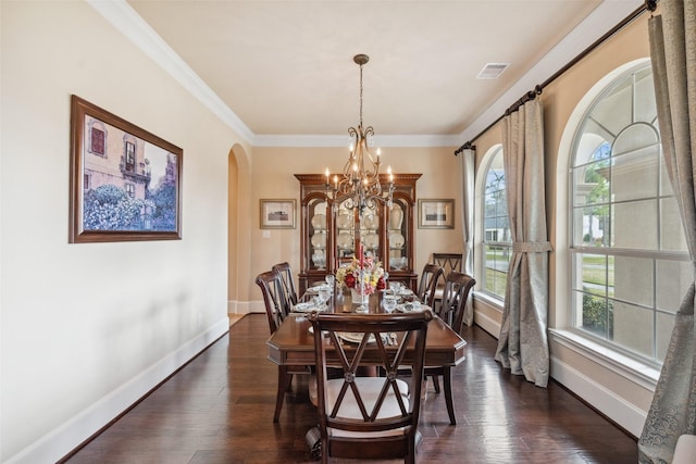 dining area featuring baseboards, dark wood-type flooring, arched walkways, and a notable chandelier