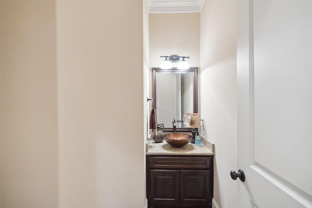 bathroom with ornamental molding and vanity