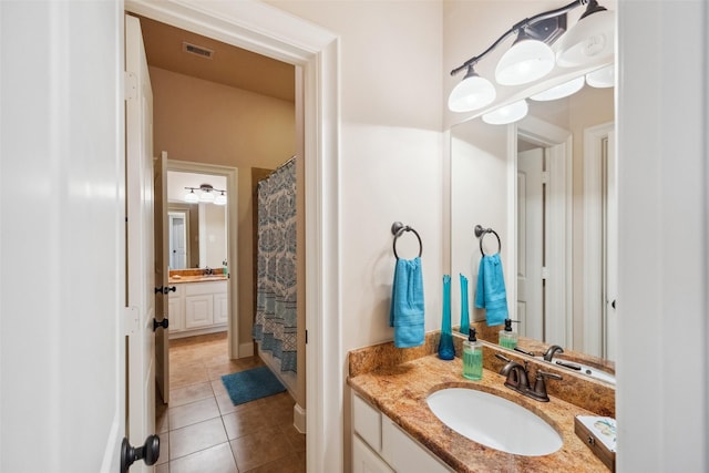 full bath with curtained shower, visible vents, vanity, and tile patterned floors