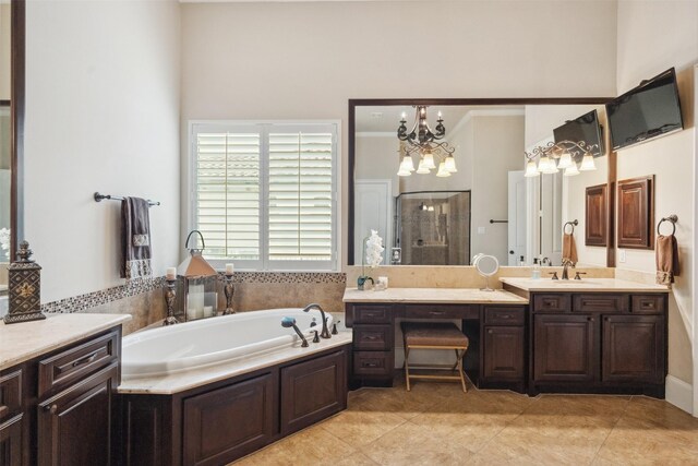 bathroom featuring tile patterned flooring, a garden tub, a shower stall, and vanity