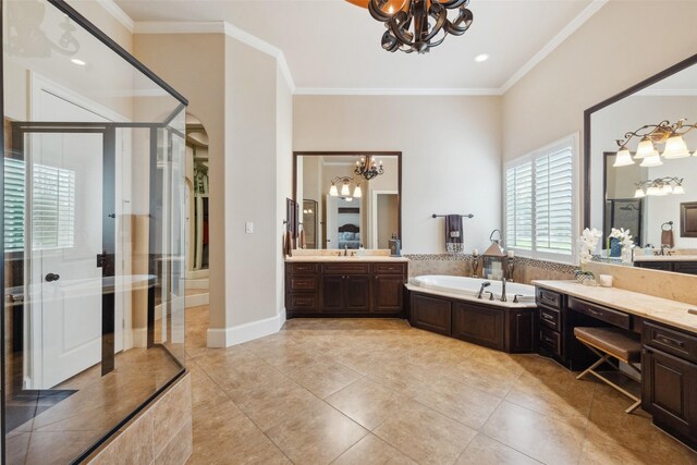 bathroom with a stall shower, ornamental molding, and a notable chandelier