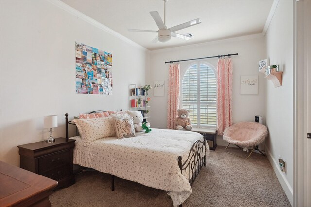 carpeted bedroom featuring ornamental molding, ceiling fan, and baseboards