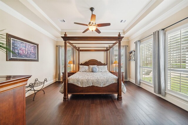 bedroom featuring baseboards, visible vents, wood finished floors, and ornamental molding