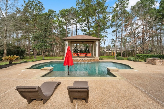 pool featuring a gazebo, outdoor lounge area, and a patio area