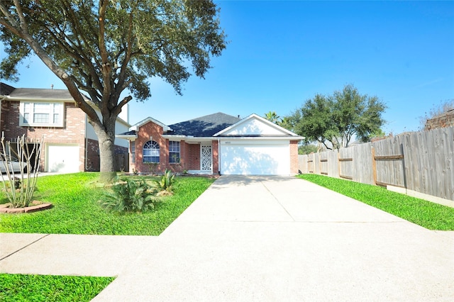 single story home with an attached garage, brick siding, fence, driveway, and a front lawn