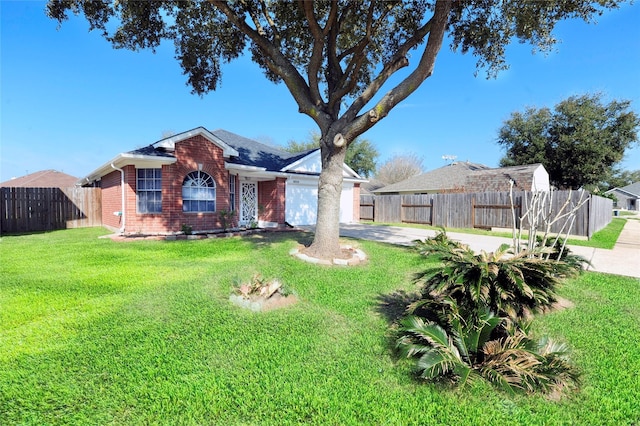 view of yard featuring a garage, concrete driveway, and fence