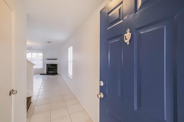 hall with light tile patterned floors