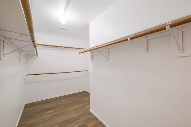 walk in closet with visible vents and wood finished floors