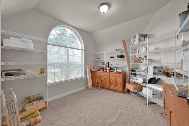 interior space featuring lofted ceiling, light carpet, and baseboards