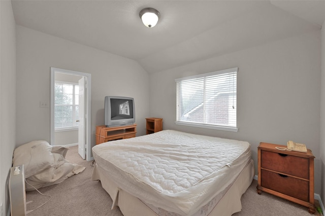 bedroom with lofted ceiling and light carpet