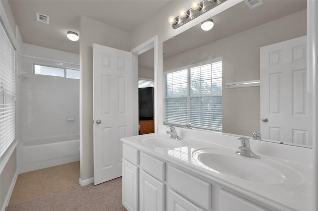 bathroom featuring double vanity, tile patterned flooring, visible vents, and a sink